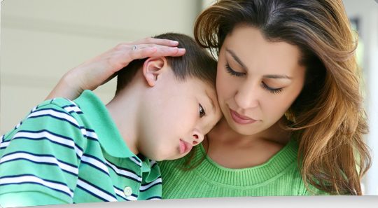 A mother comforting her young son
